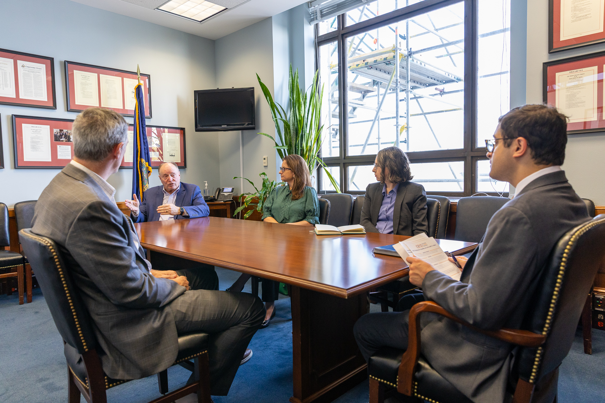 CEO Commission Partners sitting around wooden table meeting with Congressional Member 