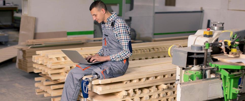 Man with prosthetic leg working on laptop